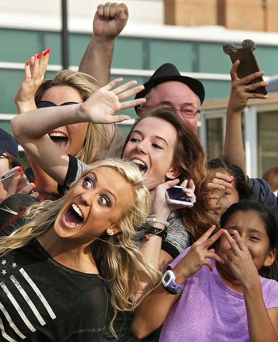 General News - 2nd place - Fans of pop music star Justin Bieber try to attract the attention of TV cameras while waiting for the doors for general admission to open at the Jerome Schottenstein Center before a concert in Columbus.  (Barbara J. Perenic / The Columbus Dispatch)