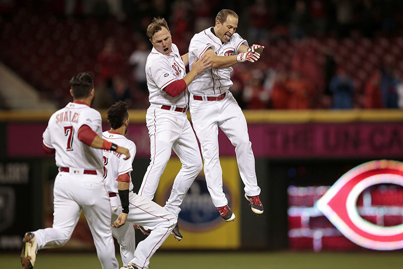 SSports Feature - 2nd place - Cincinnati Reds left fielder Scott Schebler (center) is congratulated by right fielder Jay Bruce (32) after hitting the game-winning two-run double in the ninth inning during the Opening Night MLB game against the Philadelphia Phillies.  (Kareem Elgazzar / Cincinnati Enquirer)