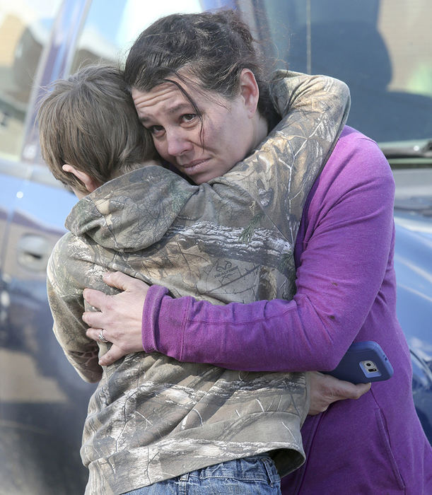 Spot News - 1st place - Crystal Johnson looks at the charred remains of her house while hugging her son, Bryden, after their home caught fire on Frederick SW in Canton.  (Scott Heckel / The (Canton) Repository)