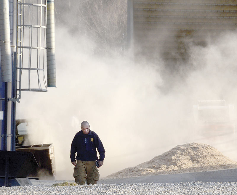 Spot News - 2nd place - Beaver Township Fire Chief Russ Osborne walks up the lane at Joe Weaver's Farm on Lesher Road. The fire department stopped at this farm following a sawdust bedding fire in the cow barn at DougWeaver's farm on Green Beaver Road. The bedding at Joe Weaver's farm was the same truckload that caught fire at DougWeaver's farm. As a precaution the bedding was removed from the storage bin. (Patricia Schaeffer / The (Lisbon) Morning Journal)