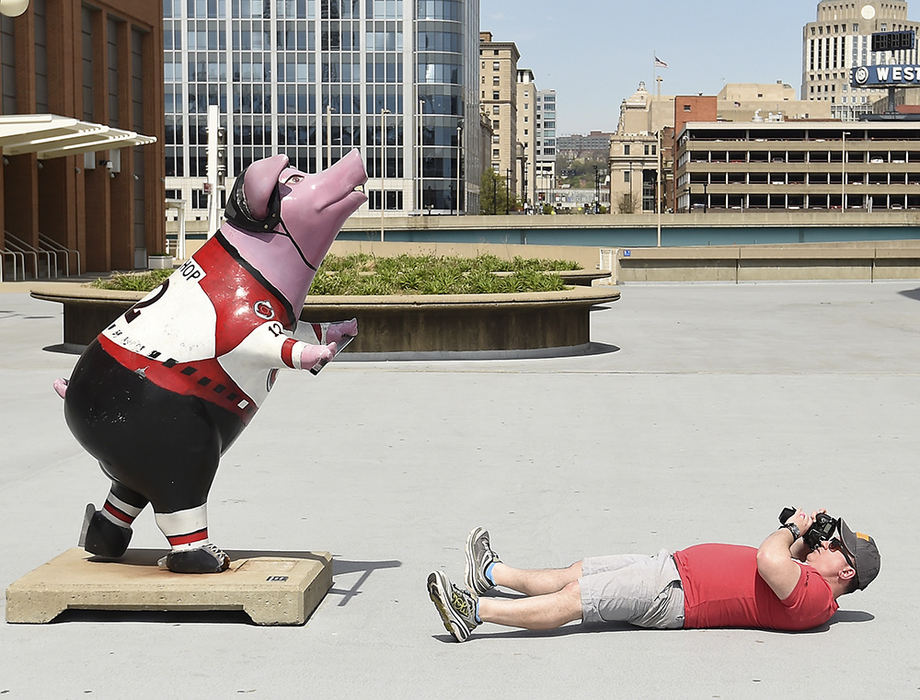 Feature - 3rd place - Brenden Haren of Ft. Thomas Kentucky lays on the ground to get a different perspective of a Cincinnati Reds Pig statue in front of Great American Ballpark in Cincinnati.  (Erik Schelkun / Elsestar Images)