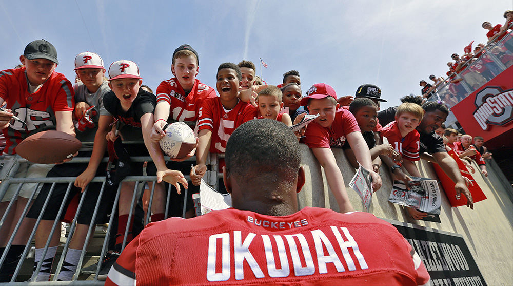 Sports Feature - 2nd place - Ohio State safety Jeff Okudah signs autographs for young fans following the Ohio State spring football game at Ohio Stadium in Columbus.  (Barbara J. Perenic / The Columbus Dispatch)