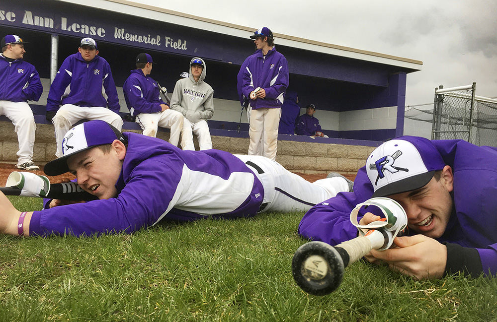 Sports Feature - HM - Fremont's Garrett Schneider (left) and Noah Hotz scope the other team during a weather delay. (Molly Corfman / The News-Messenger)