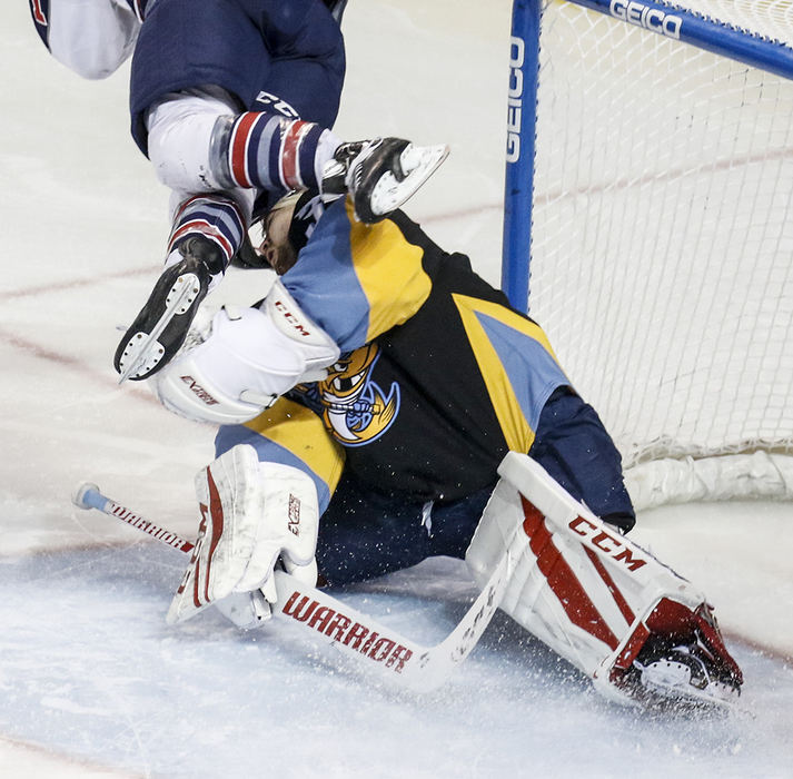 Sports - 3rd place - Toledo Walleye goalie Jake Paterson loses his helmet as he's hit by a flying Kalamazoo Wings Lane Scheidl during the second period of game one of their first round ECHL hockey playoff series at the Huntington Center.  (Andy Morrison / The Blade)