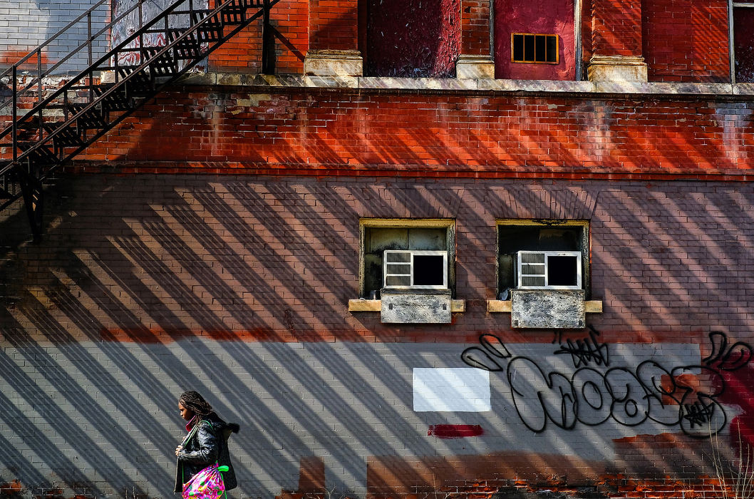 Feature - 1st placeEmoni Austin, 11, passes the River East Building on her way home from school in Toledo.  (Jeremy Wadsworth/The Blade)