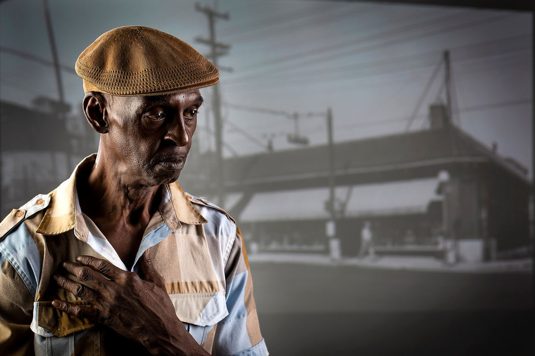 Portrait - 2nd placeLindsey Bolar of Bond Hill stands in front of a projected 1958 photo of Reading Road in Avondale at the Enquirer studio in Cincinnati. Bolar ran the streets growing up, escaping an abusive stepfather and falling into a life of crime and nearly 40 years of heroin addiction, before "clarity came" while he served prison time in California.  (Sam Greene/The Cincinnati Enquirer)