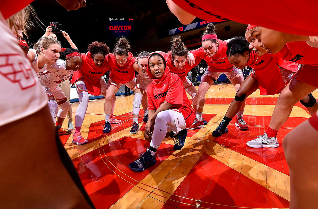 Sports Feature - 2nd placeShakeela Fowler (center) helps motivate the rest of her Dayton Flyer teammates moments before the start of their game against the Saint Louis.  (Erik Schelkun/Elsestar Images)