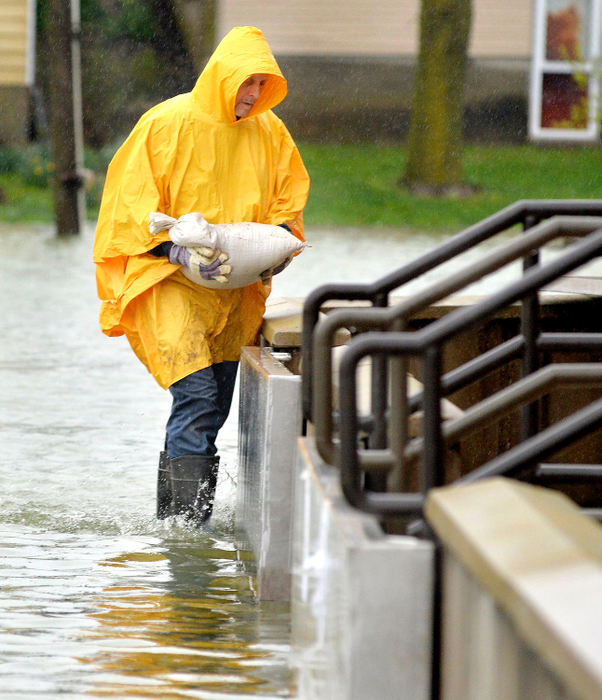 Spot News - 3rd placeGreg Noll carries a sandbag to help seal off doorways to prevent flooding at the Mercer Health's Doctors' Urgent Care in Celina. (Daniel Melograna/The Daily Standard)