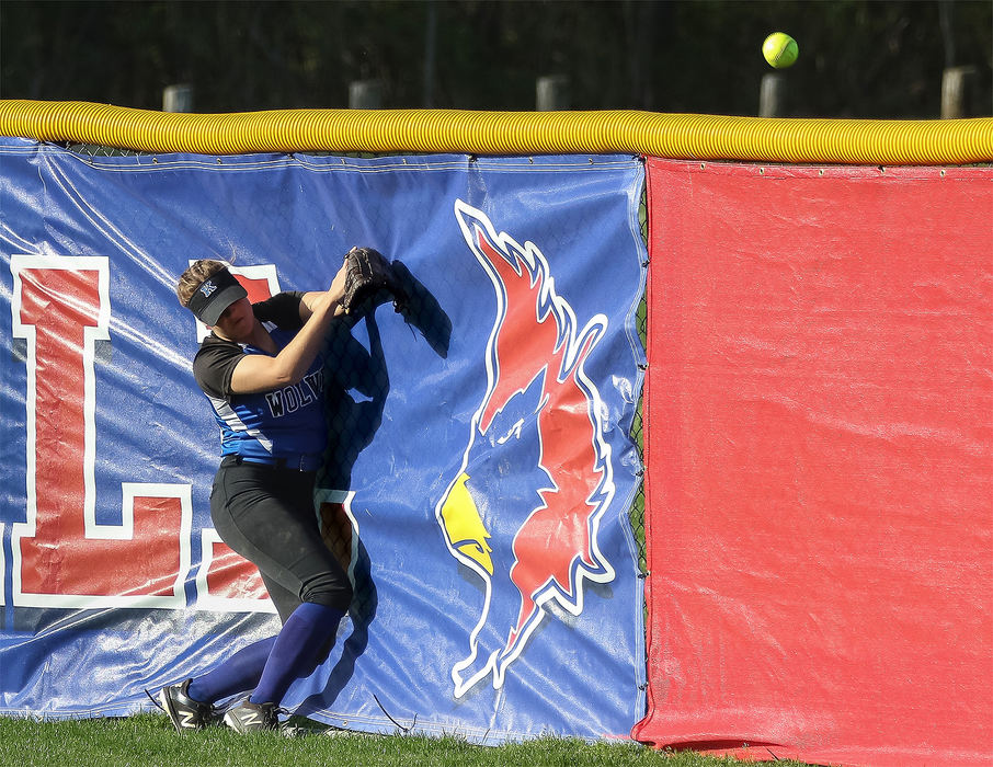 Sports - 3rd placeWorthington Kilbourne's Ava Hayes (16) attempts to catch a hit by Thomas Worthington but slams into the wall as the ball goes over the fence. (Alex Conrath/ThisWeek Newspapers)