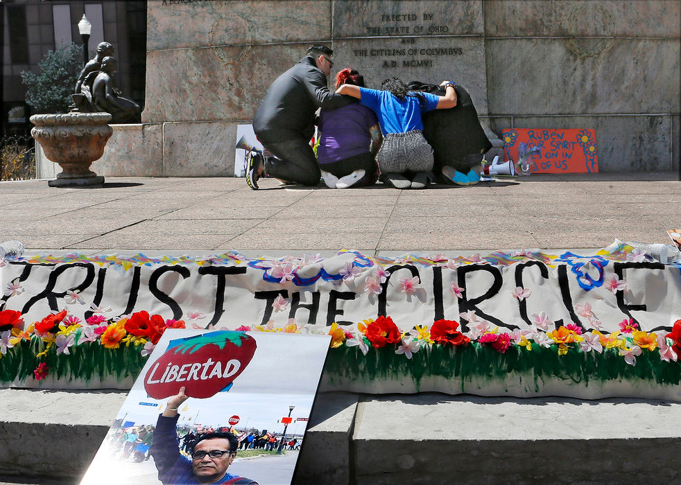 Story - 2nd placeFamily members of Ruben Herrera  a local activist gather at a make shift memorial at the statehouse during a Celebration of Life Service that begun at the statehouse April 13. Family and friends held a rally then marched to the Broad Street United Methodist Church as part of his memorial service. (Eric Albrecht/The Columbus Dispatch)