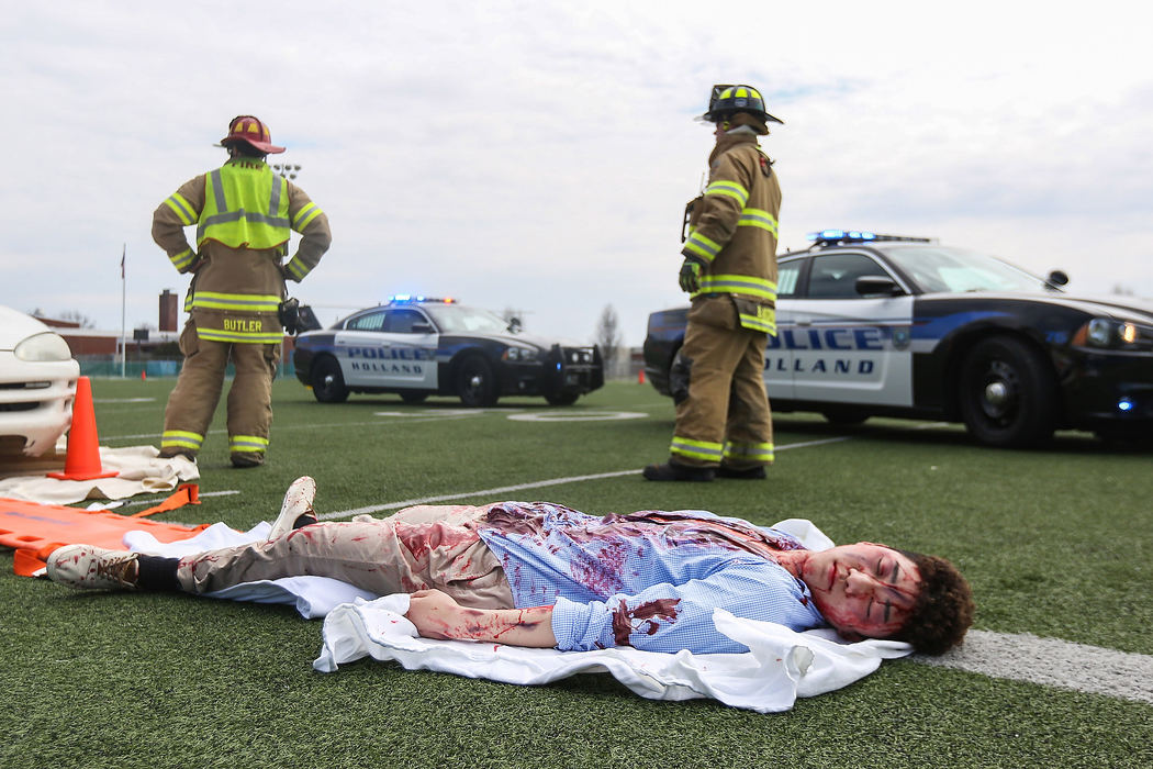 Story - 3rd placeZac Powhida lays on the ground after 'dying' during a mock drunk driving crash at Springfield High School. The mock car crash is to scare students from driving distracted or drunk ahead of prom and graduation season.  (Rebecca Benson/The Blade)