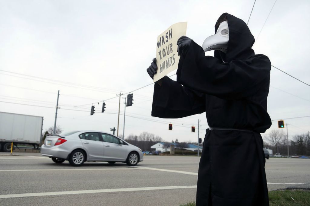 Feature - 3rd place - Colton Hartman, of Lewis Center, dons a plague doctor outfit while reminding drivers along U.S. Route 23 to wash their hands amid the COVID-19 coronavirus pandemic in Lewis Center. Shane Flanigan / ThisWeek Community News