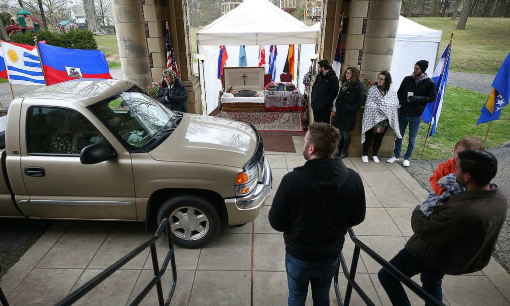 General News - 2nd place - People whose lives were touched by the late Rev. Kent Jarvis drive by to pay their respects and share kind words with his family during a drive-thru style visitation at Akron First Assembly of God. Jeff Lange / Akron Beacon Journal