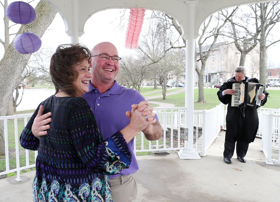 General News - HM - Newlyweds Andy and Rachel Tomcsik, both 49, dance their first dance as Judge Todd McKenney plays the Anniversary Waltz on the accordion after presiding over their wedding at the Lake Anna Gazebo in Barberton. The couple were seventh grade sweethearts that reconnected and fell in love.   Mike Cardew / Akron Beacon Journal