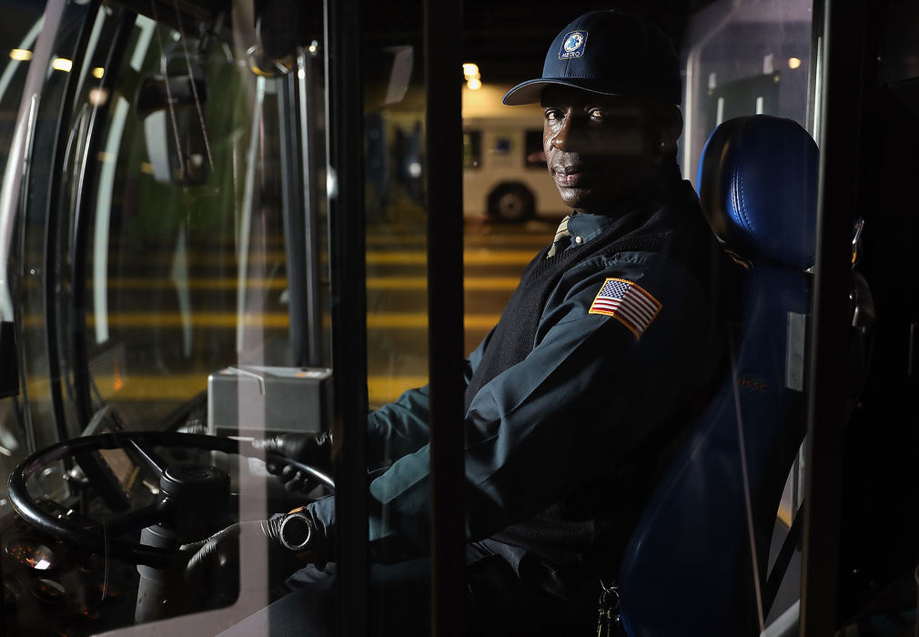 Portrait - 1st place - Orlando King, a Cincinnati Metro bus driver and essential worker sits for a portrait in his bus at Metro's Queensgate garage in Cincinnati.  Kareem Elgazzar / The Cincinnati Enquirer