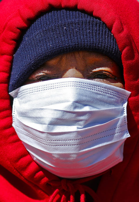 Portrait - HM - Sandy Sherman of Akron wears a protective mask as she strolls through downtown on her way to the store, April 2 in Akron.  Jeff Lange / Akron Beacon Journal