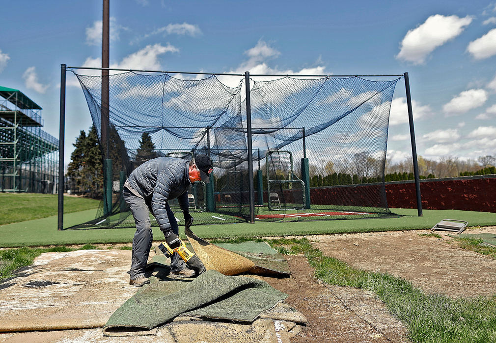 Sports Feature - 2nd place - Dublin Coffman baseball coach Tim Saunders works around the team batting cage at Dublin Coffman High School. The Ohio High School Athletic Association cancelled spring sports after Ohio Governor Mike DeWine announced that schools would remain closed for the remainder of the academic year due to the coronavirus COVID-19.  Kyle Robertson / The Columbus Dispatch