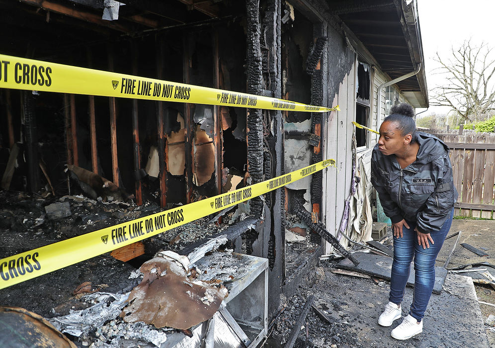 Spot News - 1st place - Tielissa Sowell looks over her aunt's apartment on East John Street after it was destroyed by fire overnight. Several units in the Springwood Apartment complex were damaged or destroy by the fire. There were no injuries.  Bill Lackey / Springfield News-Sun