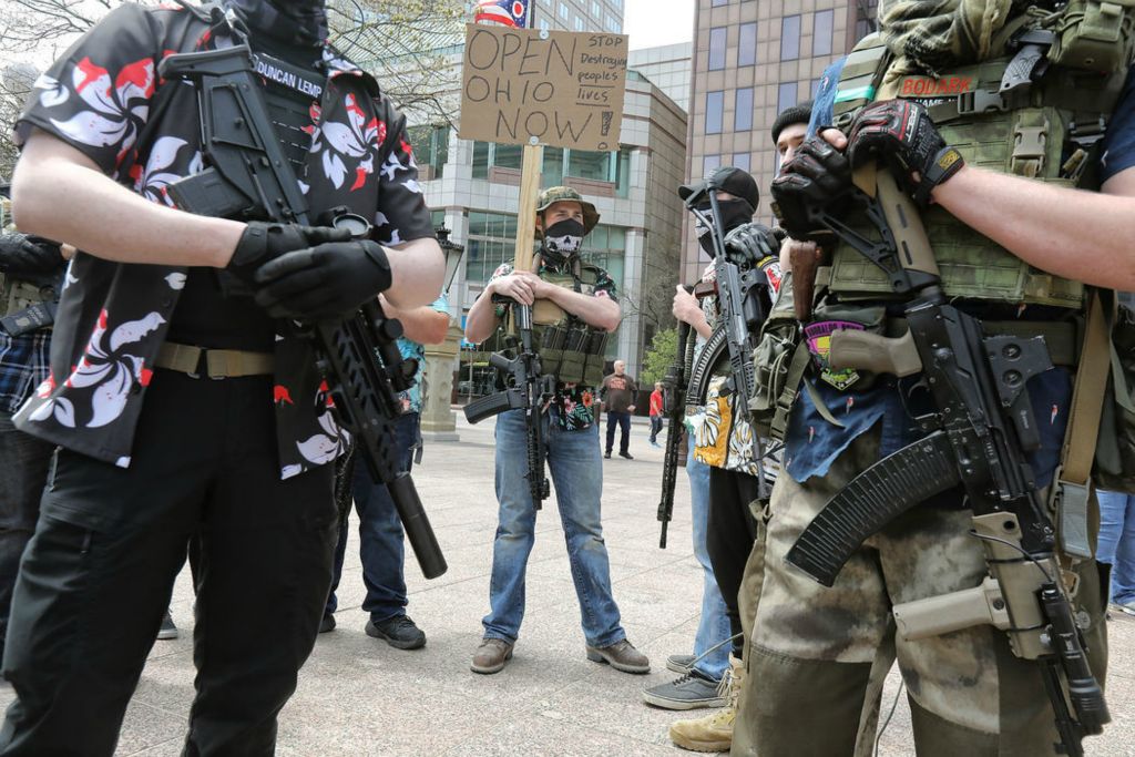 Story - 3rd place - Members of Patriot Wave stand guard during an "Open Ohio Now Rally" at the State House in Columbus. Several hundred people participated in a rally demanding Governor Mike DeWine reopen Ohio amid the COVID-19 pandemic.  Jeremy Wadsworth / The Blade