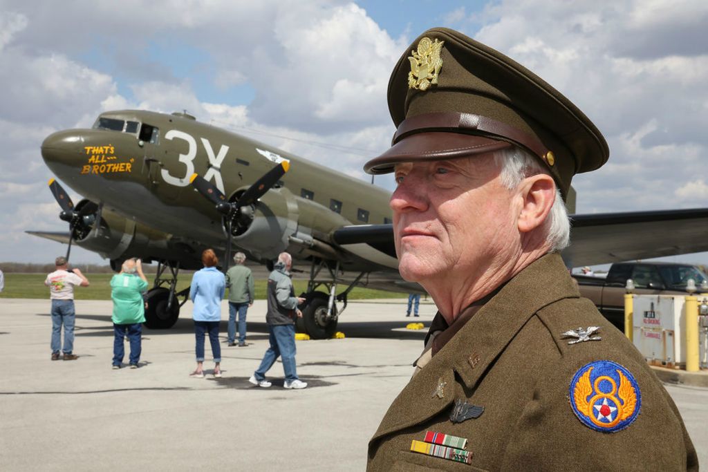 Portrait - 3rd place - Glen Fike, a WWI and WWII re-enactors from the National Museum of the United States Air Force, was on hand, in uniform, when the "That's All, Brother" C-47 airplane arrived at Grimes Field in Urbana. In 1944, the plane led over 800 C-47's that dropped over 13,000 paratroopers into battle as part of D-Day.  (Bill Lackey / Springfield News-Sun)