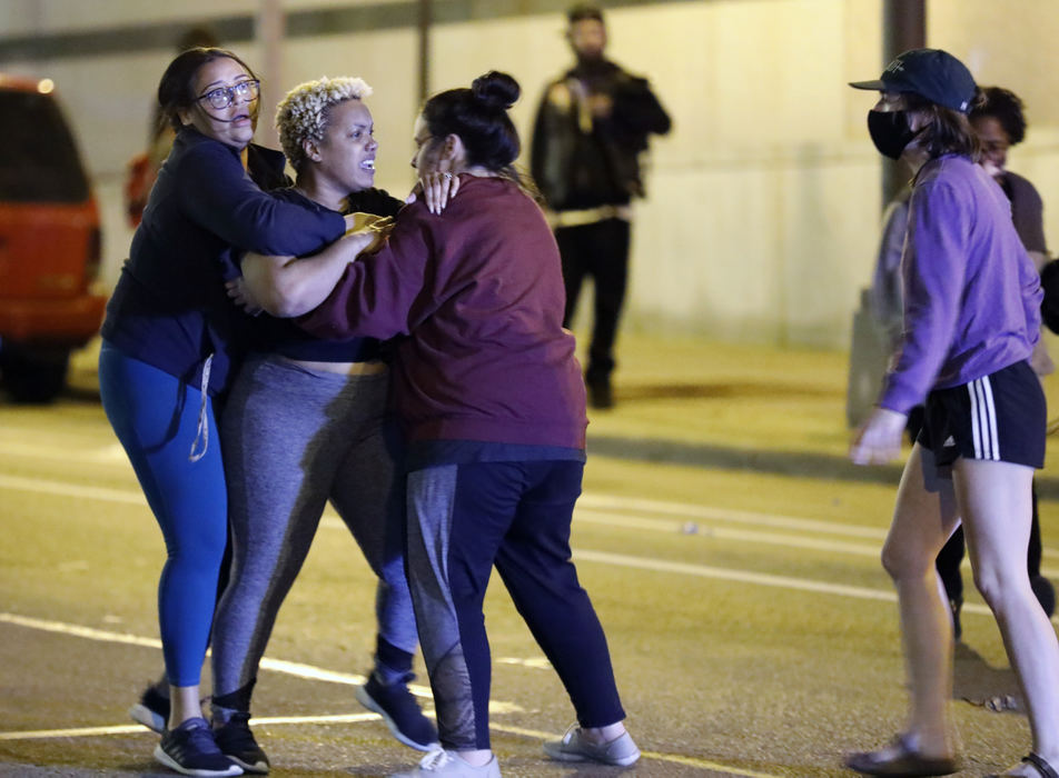 Spot News - 1st place - Hana Abdur-Rahim is held back while yelling towards Columbus Police after pepper spray was deployed on a group protesters after they broke a lock and entered the Police building on April 13. A peaceful march with over 100 demonstrators took to the streets earlier in the evening.  Miles Jackson was shot and killed inside Mount Carmel in Westerville by police the day before.  (Kyle Robertson / The Columbus Dispatch)