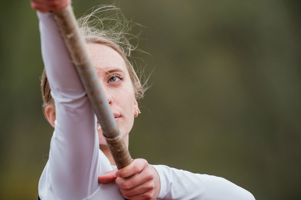 Sports Feature - 2nd place - Indian Valley's Laynee McDaniel check her grip during pole vault competition in Gnadenhutten.  (Andrew Dolph / The Times Reporter)