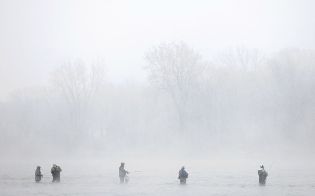 Feature - 2nd place - Anglers are shrouded in fog and snow while fishing for walleye in the Maumee River. (Kurt Steiss / The Blade)