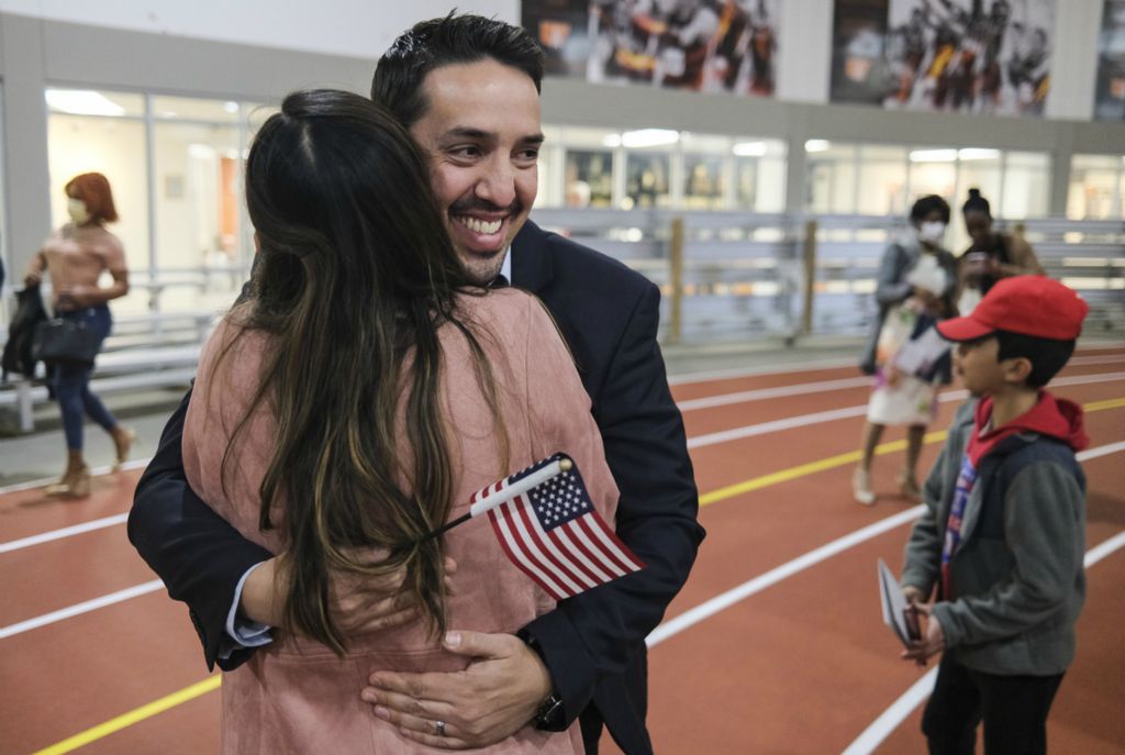 Story - HM - Fifty-nine people from 27 countries become U.S. citizens during a naturalization ceremony at the University of Findlay's Koehler Complex in Findlay. Alfredo Blank, originally from Mexico, hugs his wife Cinthya Blank after becoming a U.S. citizen during the ceremony at the University of  Findlay's Koehler Complex in Findlay. (Jeremy Wadsworth / The Blade)