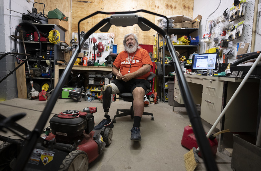 Portrait - 3rd place - Repair supervisor Henry Scott works on replacing a bent blade in a lawnmower at the ModCon Living Tool Library.  (Brooke LaValley / Brooke LaValley-The Columbus Dispatch)