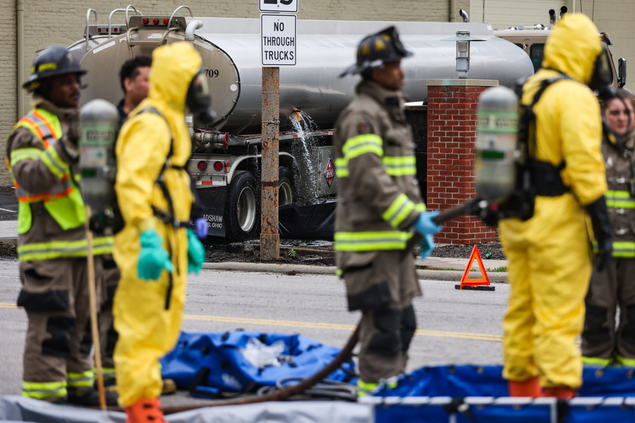 Spot News - 2nd place - A Toledo firefighter gets hosed down as gas pours out of a fuel truck on Washington Street between North St. Clair and South Summit in downtown Toledo. (Rebecca Benson / The Blade)