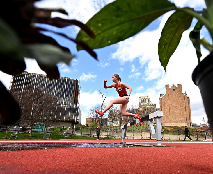 Sports - 3rd place - Dayton's Zoe Chappelle clears the hurdle into the water feature on her way to winning the 3000 meter steeplechase event at the Oliver Nikoloff invitational. (Erik Schelkun / Elsestar Images)