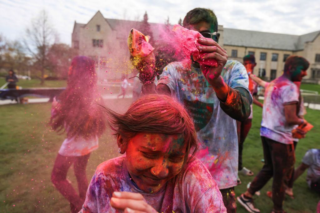 General News - 1st place - UT students throw brightly colored powders on each other during the Holi Toledo festival at the University of Toledo. Holi is a Hindu festival that originated in India and symbolizes the arrival of spring, the end of winter and the blossoming of love.  (Rebecca Benson / The Blade)