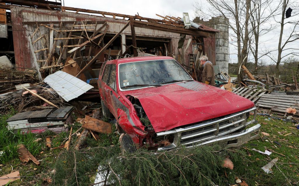 Spot News - 2nd place - A Windham resident searches through rubble for belongings after Wednesday night’s EF-1 tornado. (Jeff Lange / Akron Beacon Journal)