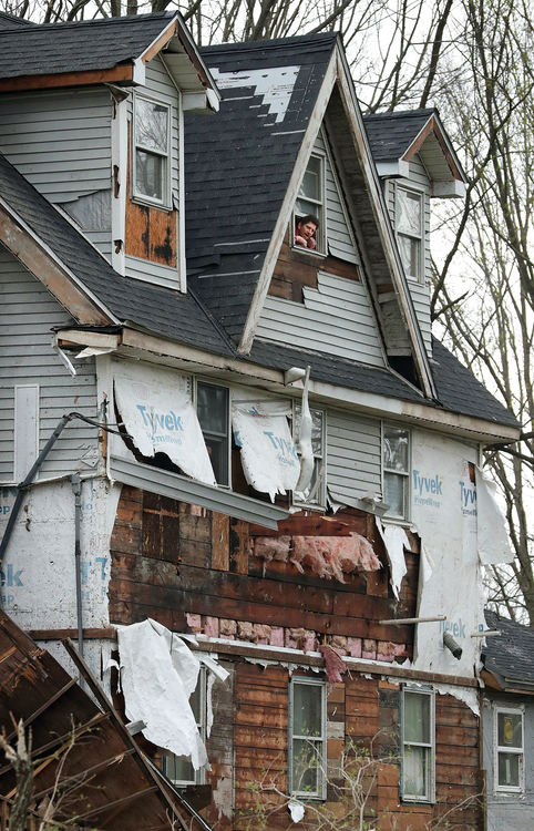 Spot News - 3rd place - Aherin Silver surveys the damage done to his property from the third floor of his home on Windham - Parkman Road the morning after an F1 tornado skipped through the village, in Windham. Silver said he was on the third floor of his home when the tornado came through. (Jeff Lange / Akron Beacon Journal)