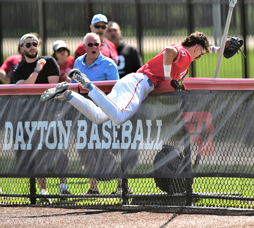 Sports - 3rd place - Dayton first baseman Edie Yamin IV makes a catch over the fence at Woerner field during a game against George Mason.  (Erik Schelkun / Elsestar Images)