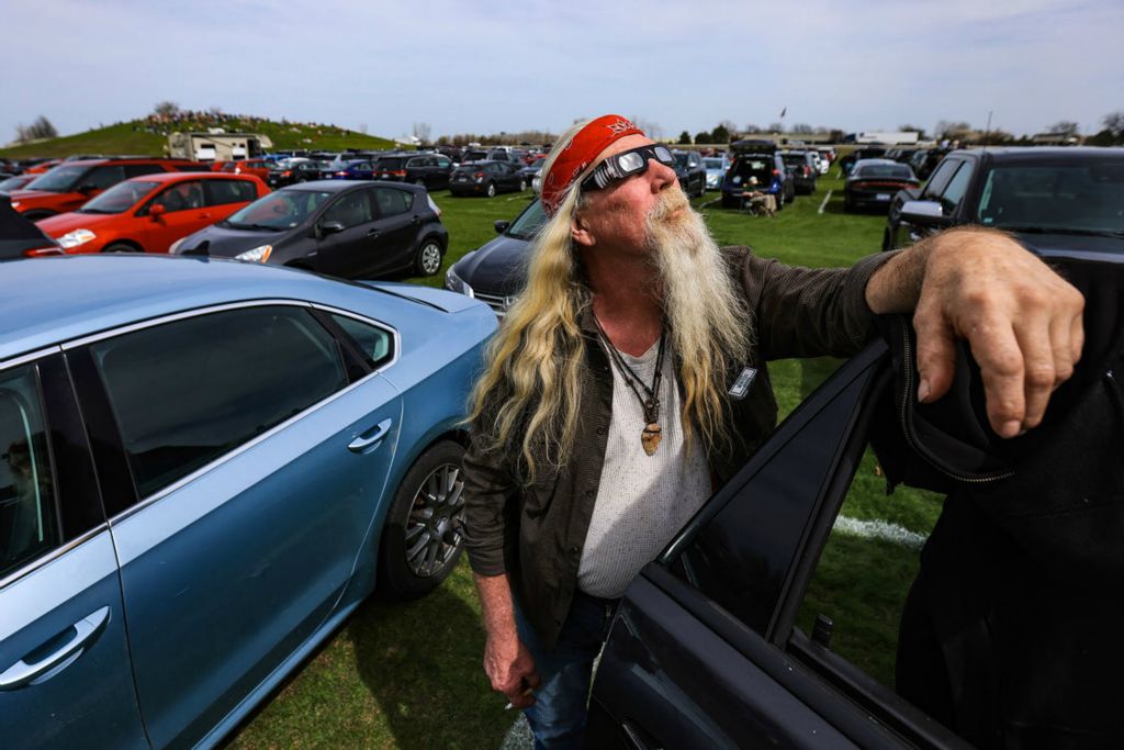 Story - 1st place - Jeff Willis, of Erie, Michigan watches the eclipse from the parking lot during BGSU’s Total Solar Eclipse Watch Party at Doyt Perry Stadium in Bowling Green. (Rebecca Benson / The Blade)