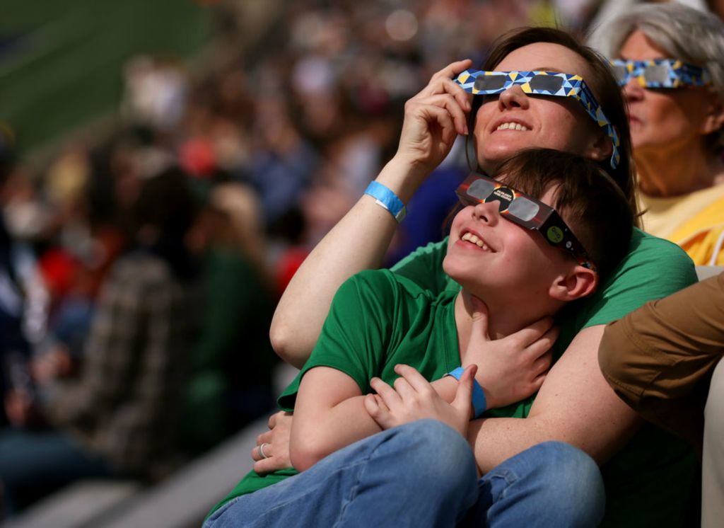 Story - 2nd place - Midland, Michigan residents Vicki Wakeman and 8-year-old David Wakeman watch as the eclipse nears totality at the University of Toledo’s Glass Bowl. (Kurt Steiss / The Blade)