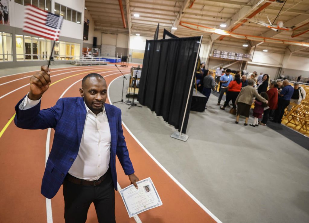 Story - 3rd place - Jackson Rugero, originally from the Congo, celebrates becoming a U.S. citizen during a naturalization ceremony at the University of Findlay’s Koehler Fitness and Recreation Complex. (Jeremy Wadsworth / The Blade)