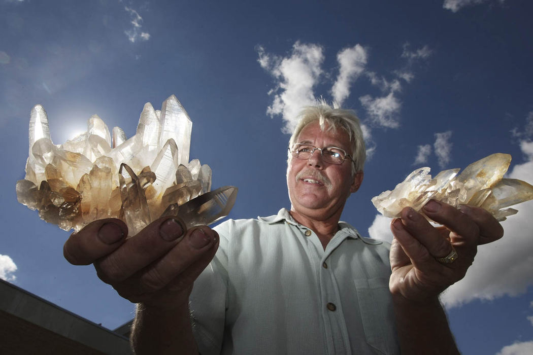 Portrait - HM - Rodney Eakin, collector and researcher of natural history from Grove City holds up a quartz crystal from Mt. Ida in Arkansas outside the Grove City Town Center.  (Neal C. Lauron / The Columbus Dispatch)