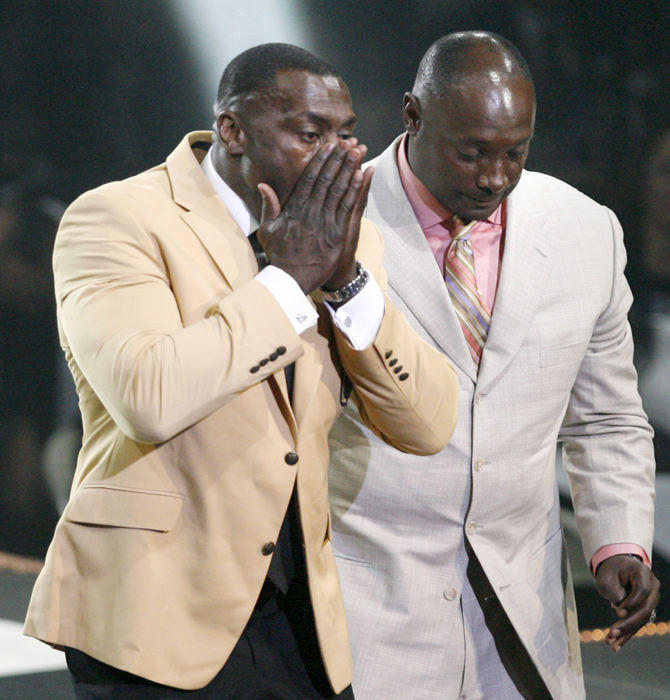 Sports - 1st place - Shannon Sharpe wipes away tears after receiving his gold jacket from his brother Sterling at the Pro Football Hall of Fame Festival Enshrinees Dinner at the Memorial Civic Center in Canton. Sterling  presented Shannon for induction into the Pro Football Hall of Fame the following day. (Scott Heckel / The (Canton) Repository)