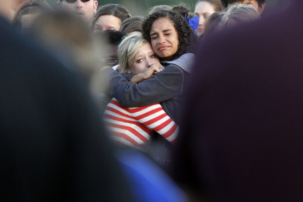 General News - 2nd placeSixteen year-olds Shelby Cook (left) and Kara Maddox console each other during a vigil for their dear friend and fellow Hilliard Bradley marching band member David Phillips III.  Phillips died in a car accident.  The speakers at the vigil spoke of Phillips' smile and how he made others smile. The band will wear armbands in his honor with the phrase "He lives smiling"  and the football team will wear trumpet decals on their helmets.   (Lorrie Cecil / ThisWeek Newspapers)