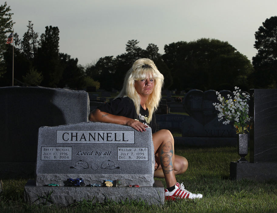 Portrait - 2nd placeDebbie Channell lost her sons B.J., 9, and Brett Channell, 8, in a fire at a home they occupied in Richwood on Dec. 8, 2004. Their faces are tattooed on her right calf. She is posing at their grave in Plain City. (Jonathan Quilter / The Columbus Dispatch)