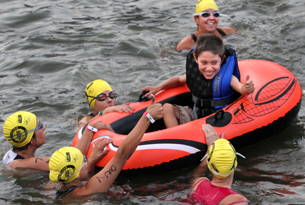 Sports feature - 2nd placeTeam Niko is ready to push, pull and otherwise propell their team's namesake, seven year old Niko Lanzarotta, through the swim portion of the super sprint competition of the Cleveland Triathlon. Niko has cerebral palsy and he and his family have competed in the triathlon for the five years that United Cerebral Palsy has been a sponsor of the event. (Lynn Ischay / The Plain Dealer)