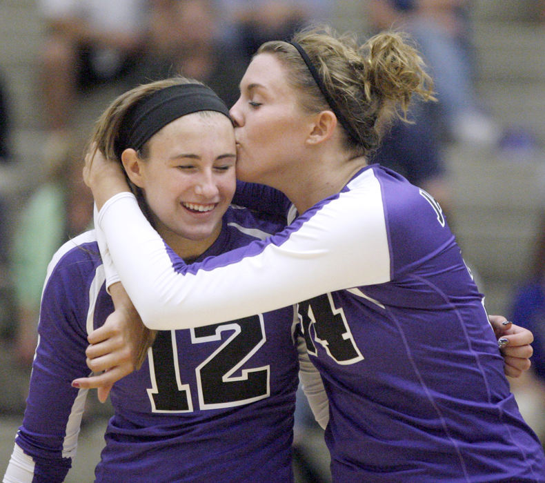 Sports feature - 3rd placeJackson's Stephanie Spencer (left) receives a kiss from teammate Paige Hill after the Polar Bears Beat Perry in the second game of their match at Jackson High School. (Scott Heckel / The Repository)