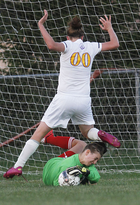 Sports - 1st placeColumbus School for Girls' goalie Olivia Feldman makes the save as Reynoldsburg's Alex Thorn collides with her during the first half of their game at Reynoldsburg. (Lorrie Cecil / ThisWeek Newspapers)