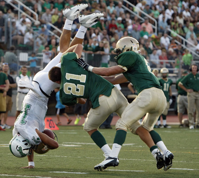 Sports - 2nd placeDublin Jerome's Justin Stroup (21) tackles Dublin Coffman's James Walsh (16) without a helmet during a two point conversion stop during the 1st half of their game at Dublin Jerome High School. (Kyle Robertson / The Columbus Dispatch)