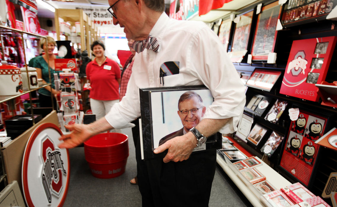 Dr. Gordon Gee walks through the  Koehler Drug Store in Upper Sandusky. Dr. Gee was presented with a photo of himself. The store devotes a lot of space to OSU themed novelties. (Eric Albrecht / The Columbus Dispatch)