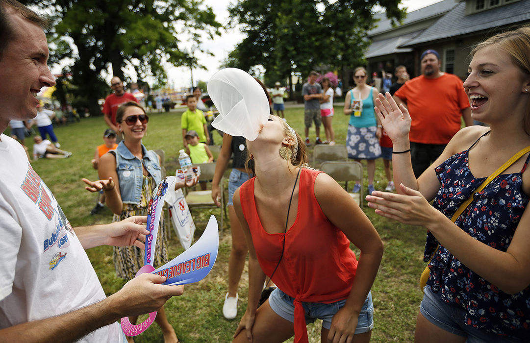 Feature - 1st placeWith her cousins cheering her on, Brooke Hamann of Hilliard bursts her bubble during the contest sponsored by Big League Chew and Kroger at the Ohio State Fair. Hamann finished in 4th place in the over 12-year-old division.  (Adam Cairns / The Columbus Dispatch)