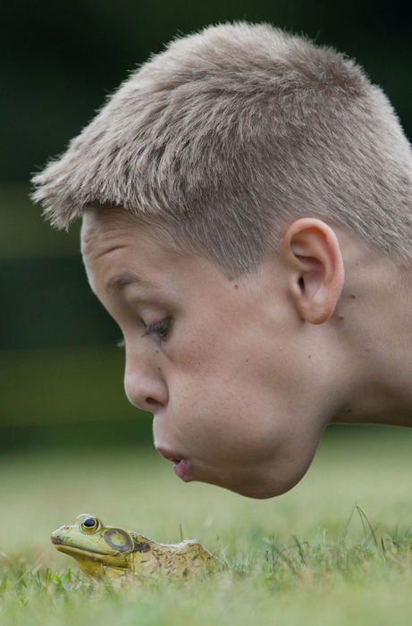 General News - 2nd placeTyler Pickup of Bolivar blows on his frog in attempt to make it jump during the 44th annual Fairfield Boys Club’s  frog-jumping contest at the Fairfield Community Center. (Daniel Kubus / Ohio Univesity )