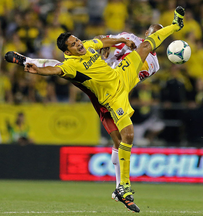 Sports - 1st placeColumbus Crew forward Jairo Arrieta (25) fights for a ball with New York Red Bulls defender Jamison Olave (4) in the 2nd half during their MLS game at Crew Stadium in Columbus.  (Kyle Robertson / The Columbus Dispatch)